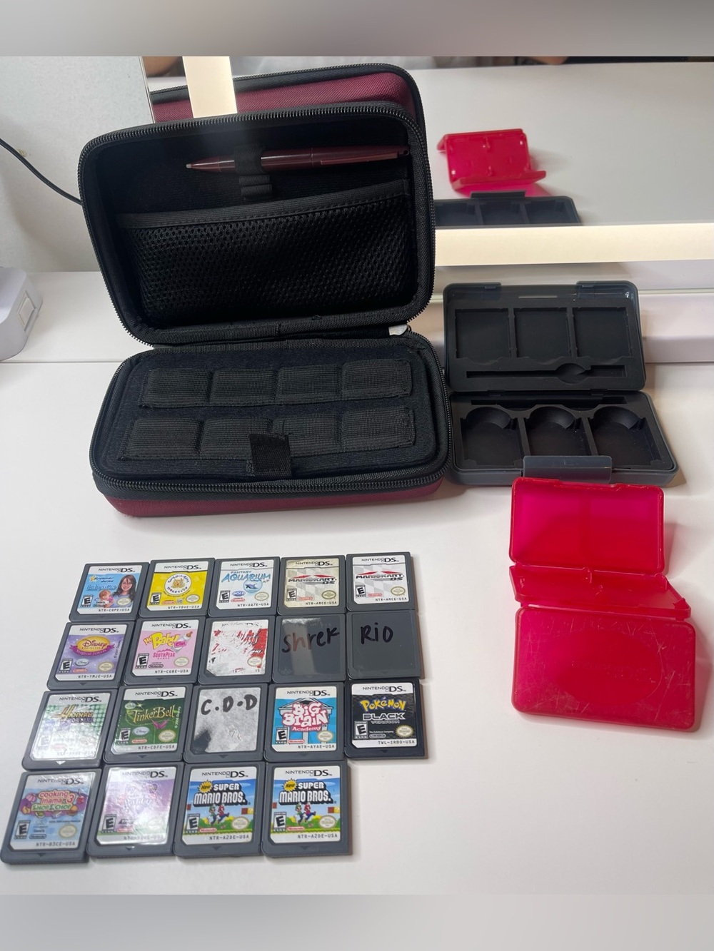 19 Nintendo DS games and Nintendo DS XL case with travel game cases and stylus